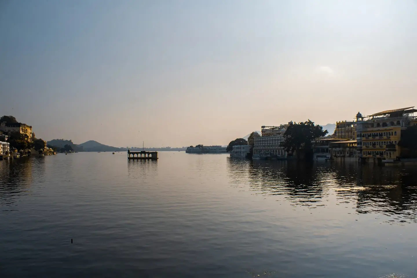 Scenic lake view with Aravalli hills in Udaipur marking the destination of the Surat to Udaipur road trip.
